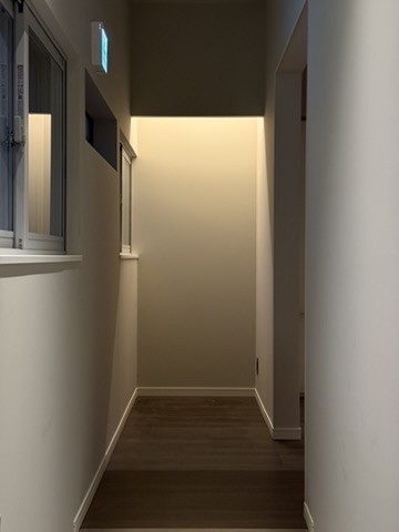 Lower Suite: a corridor washed with warm light