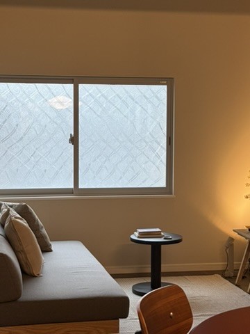 Upper Suite: sofa and side table beneath a patterned-glass window